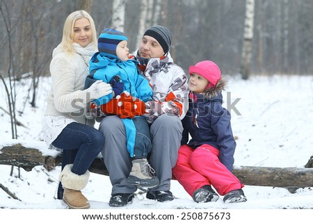 Family walking in winter forest