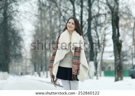 young european model in stylish clothes in the winter forest
