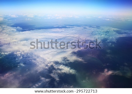 view from the bird\'s-eye view of the airplane window at the horizon and clouds