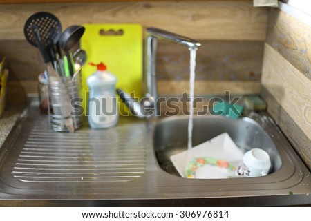 dirty dishes in the sink in the kitchen at home