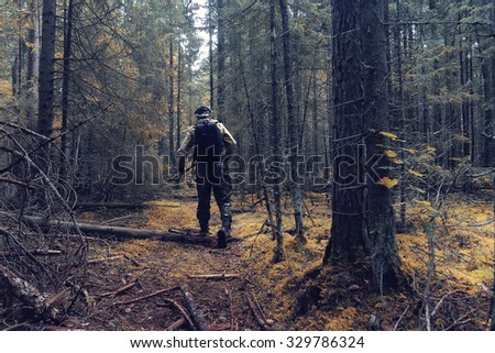 ranger in autumn forest, forester guide