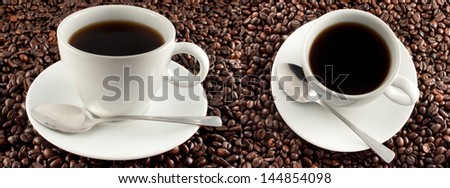 Two images side by side showing different perspectives of a cup of espresso coffee on dark brown fresh roasted coffee beans