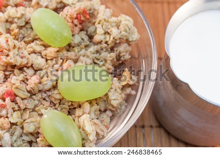 bowl of cereals with milk and fresh grapes