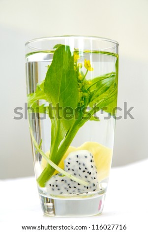 Dragon fruit and apple cut a heart shape in the water glass for decorated