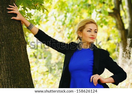 Young girl with casual wear in the autumn time park
