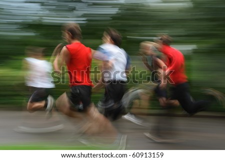 Group of young runners in moving. shooting with long exposure for blur effect.unrecognizable faces