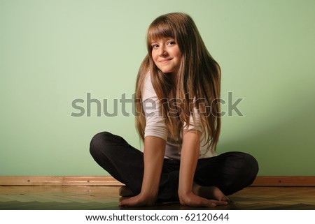 young girl with serenity look against green wall