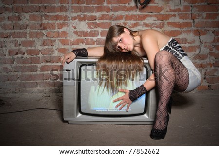 young girl on vintage TV receiver. expressed face