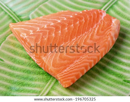 salmon steak red fish on banana leaf plate