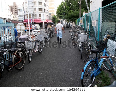TOKYO, JAPAN- AUGUST 20, 2013: Bicycle parking on footpath at Tsukiji market, that is a large market for fish, fruits and vegetables in central Tokyo, Japan. August 20 2013