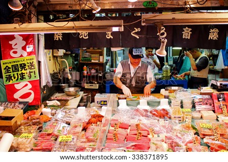 TOKYO, JAPAN - OCTOBER 3, 2015: Unidentified man preparing goods in sea food shop at Tsukiji market. It is a large market for fish in Tsukiji district, Chuo ward, Tokyo, Japan. October 3 2015
