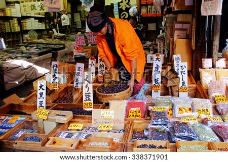 TOKYO, JAPAN - OCTOBER 3, 2015: Unidentified man preparing goods in shop at Tsukiji market. It is a large market for fish in Tsukiji district, Chuo ward, Tokyo, Japan. October 3 2015