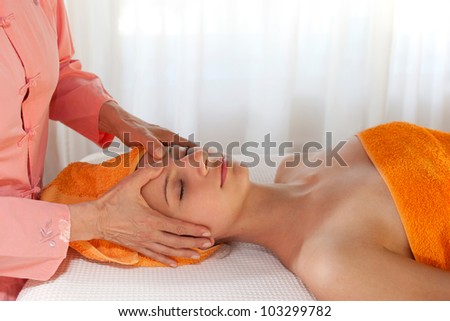 Beauty Therapist Giving Facial Massage