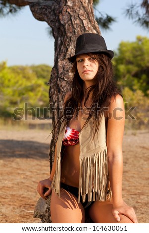 model posing in bikini and cover up wearing a fedora hat
