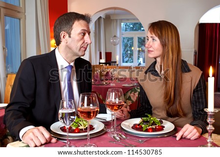 Man and woman share a heated glance at mealtime