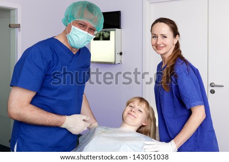 Smiling dental surgeon, assistant and patient. Smiling dental surgeon assistant and patient before dental procedure