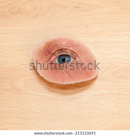 Synthetic Eye and Skin for Destroyed Eye Sockets, on Wooden Table. Also Used for Films.