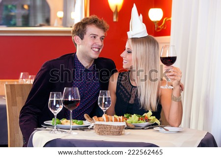 Young Sweet White Lovers at the Table Making Fun During Dinner Date. Captured Indoor of Restaurant.