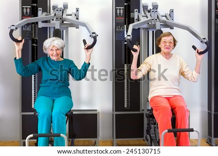 Front View of Two Old Happy Women Exercising at the Fitness Gym to Stay Healthy.