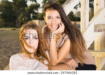 Close up Attractive Young Women Sitting on Cottage Stairs While Looking at the Camera.