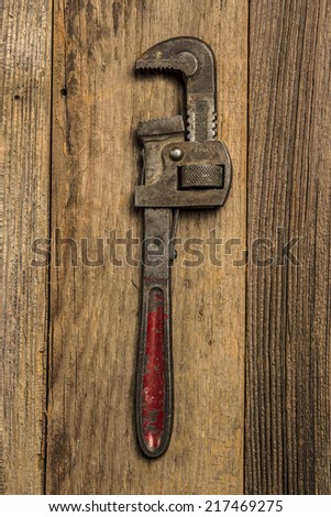 Pipe Wrench On Wood Background Texture