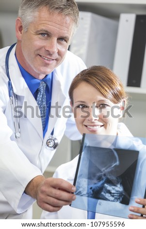 Male & female medical doctors with x-rays in a hospital