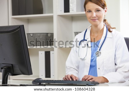Woman female medical doctor using computer in her hospital office