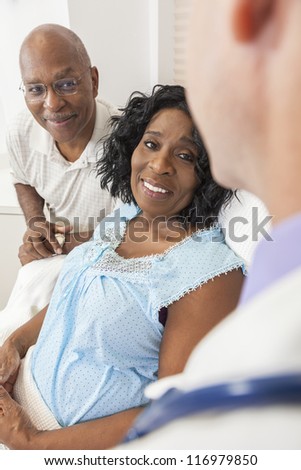 Happy senior African American woman patient recovering in hospital bed with male doctor and husband