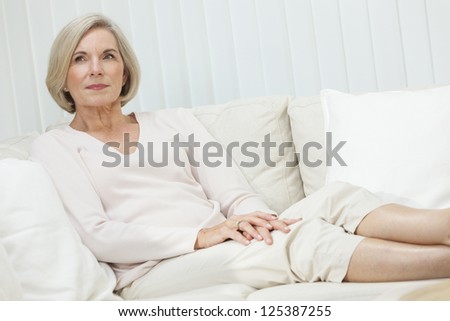 Portrait of an attractive elegant senior woman sitting relaxing at home.