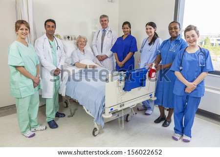 Senior Female Woman Patient In Hospital Bed Surrounded By The Multi Ethnic Interracial Medical Team Of Men And Women Male And Female Doctors And Nurses