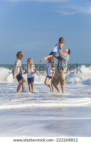 Family mother, father, daughters, parents and female girl children on vacation playing in the sea on a beach