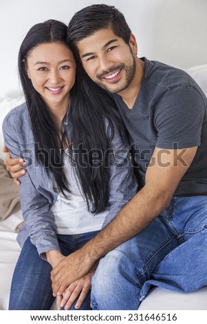 Asian Chinese man woman happy romantic couple relaxing together at home.