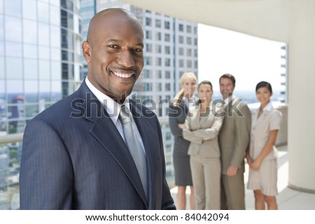 African American businessman and an interracial group of business men & women, businessmen and businesswomen team