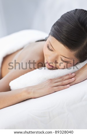 An Asian Chinese woman relaxing outside at a health spa