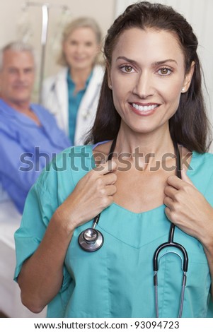 Happy, smiling, female doctor with stethoscope in foreground senior male patient in bed and senior woman doctor in background