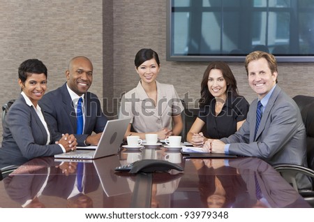 Interracial group of business men & women, businessmen and businesswomen team meeting in boardroom