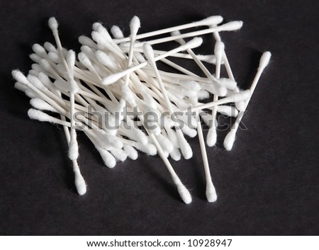 Cotton swabs lying on a black background