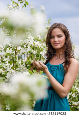 Beautiful, young, the girl with flowers of an apple-tree, in the summer