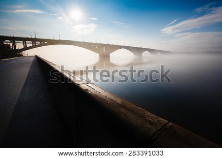Krasnoyarsk, Russia - May 29, 2015: The embankment the bridge through the river Yenisei