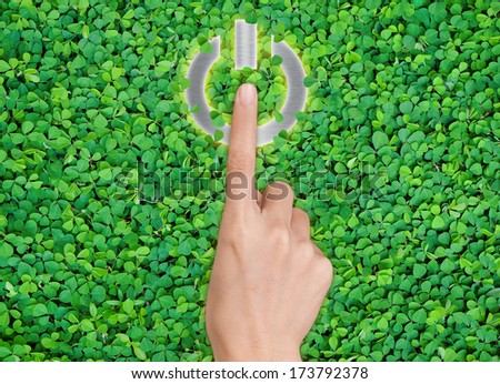hands pressing shut Down button on green leaf background