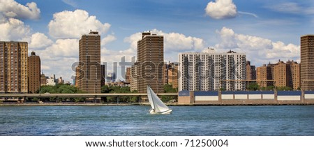 Sailboat on City River/Sailboat on East River/Sailboat on East River in New York City on summer day.