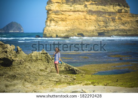 woman walks alone on a green reef