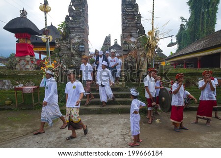 UBUD, BALI, INDONESIA - JUNE 25: Unidentified local people wearing in traditional indonesian clothes take part in traditional Balinese ceremony on June 25, 2013 in Ubud, Indonesia
