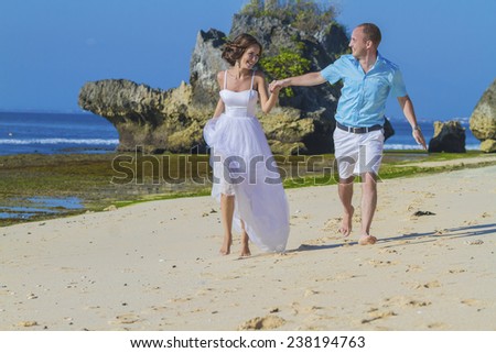 Loving Wedding Couple on Ocean Coastline.Bali.Indonesia.