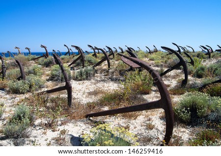 Anchors, Admiralty Pattern, at an anchor cemetery on the dunes of Barril beach. Tavira, Algarve, Portugal.