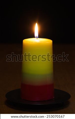 Tricolor homemade craft candle lit in the dark. Series on making craft candles.