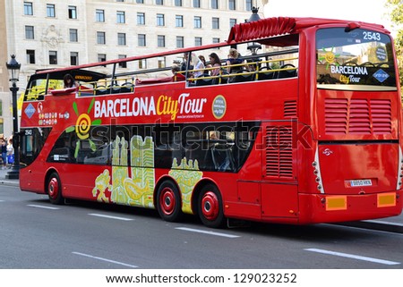 BARCELONA, SPAIN - JULY 11: Tourist bus in Barcelona, Spain on July 11, 2012. Barcelona City Tour is a new official touristic bus service that shows the city with an audio guide.