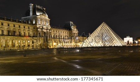 PARIS, FRANCE - OCTOBER 20: Louvre Pyramid at night in Paris, France on October 20, 2013. The Louvre is the biggest Museum in Paris and one of the major tourist attractions.