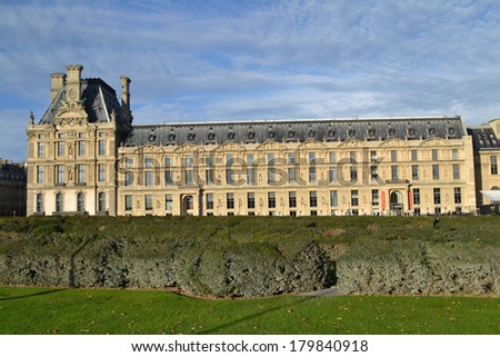 PARIS, FRANCE - OCTOBER 18: View of Louvre Museum from the Tuileries Garden in Paris, France on October 18, 2013. The Louvre is the biggest Museum in Paris and one of the major tourist attractions.