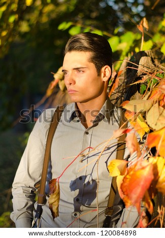 Attractive young male model in fall (autumn) outdoors in nature